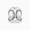 The 14K White Gold Black and White Diamond Intertwined Ring features interlocking ovals set with alternating rows of black and white diamonds, displayed on a plain white background.