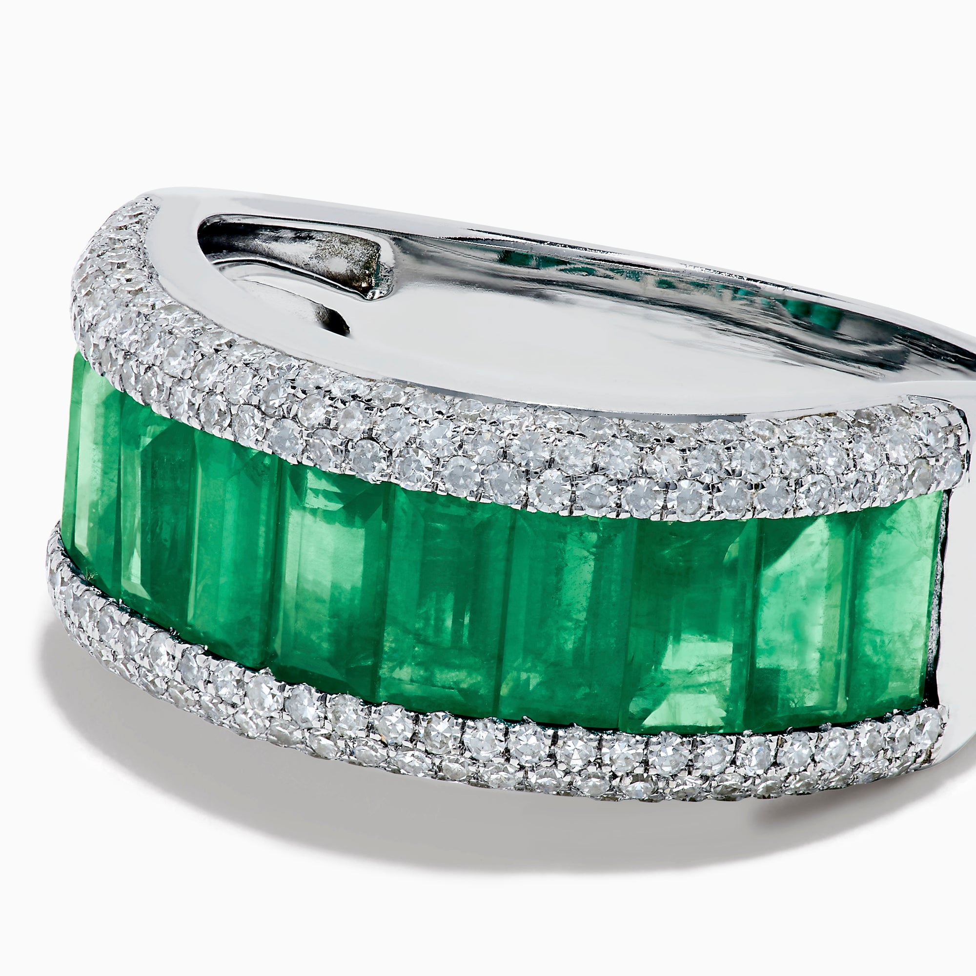 The 14K White Gold Emerald Baguette and Diamond Pavé Ring showcases a central row of emerald baguettes, flanked by rows of sparkling pavé diamonds on both sides.