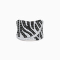 The 14K White Gold Black and White Diamond Zebra Print Ring features a wide, curved band with a striking black and white diamond stripe pattern set in sparkling white gold.