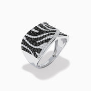 The 14K White Gold Black and White Diamond Zebra Print Ring features a wide, curved band with a striking black and white diamond stripe pattern set in sparkling white gold.