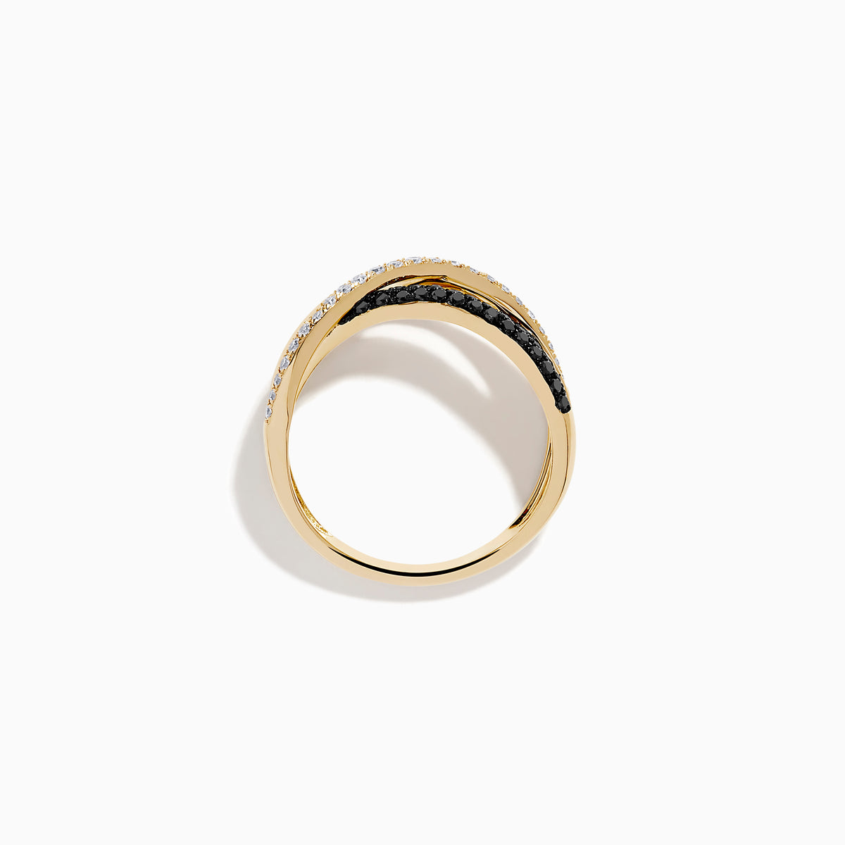 The 14K Yellow Gold Black and White Diamond Crossover Ring features three intertwined bands: a polished gold band, a black and white diamond band, and a clear diamond wave-patterned band.
