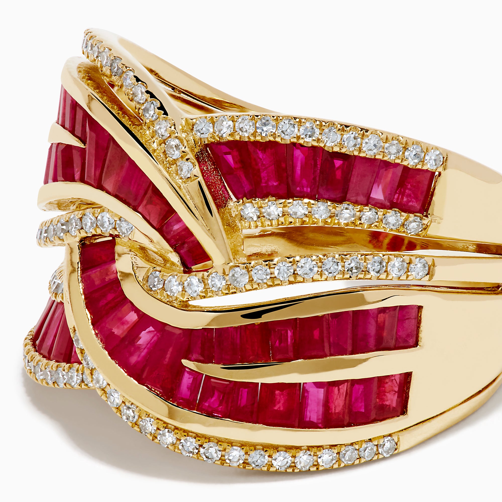 The 14K Yellow Gold Ruby and Diamond Crossover Ring showcases interwoven rows of rectangular red rubies and round white diamonds in a wavy, braided design across the band.