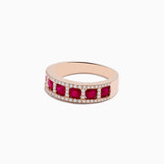 The Ruby Royale 14K Rose Gold Ruby and Diamond Band features five round rubies, each accented by small white diamonds in two parallel rows, displayed against a plain white background.
