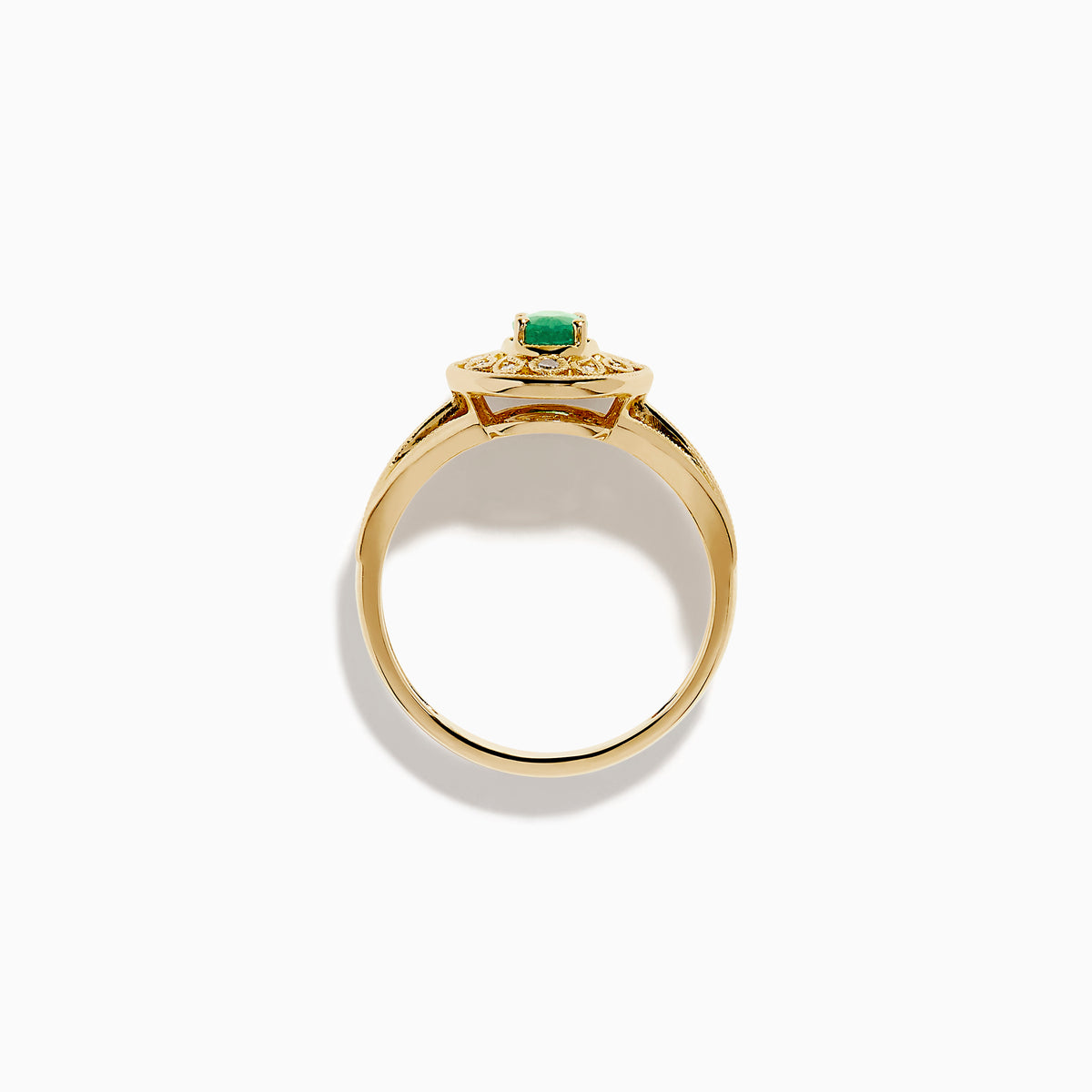 The 14K Yellow Gold Emerald and Diamond Filigree Halo Ring showcases a central oval green emerald, surrounded by a sparkling diamond halo and diamonds set along the split band.