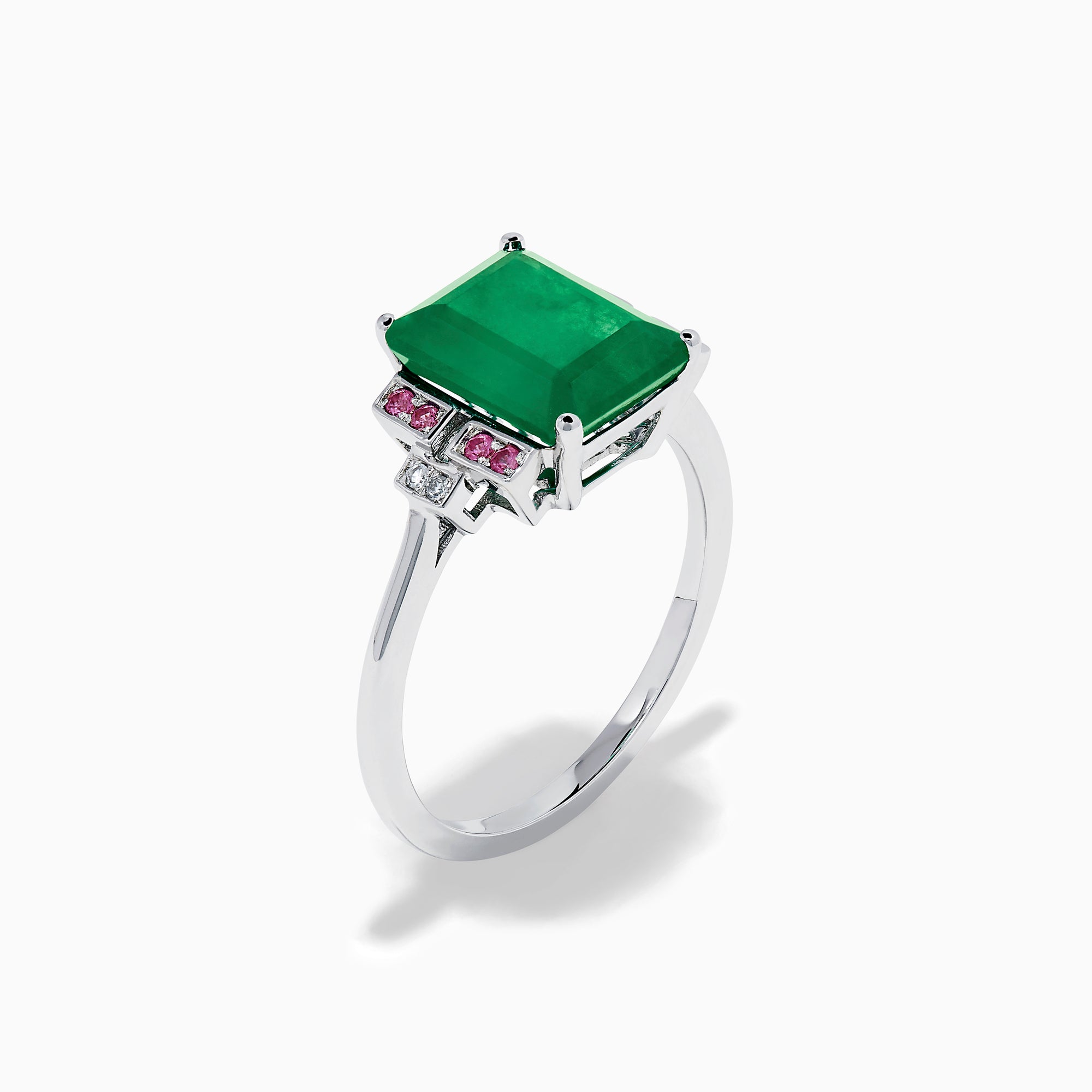 The 14K White Gold Emerald, Pink Sapphire, and Diamond Ring features a vibrant green emerald accented by pink sapphires and diamonds in modern geometric settings for an elegant look.