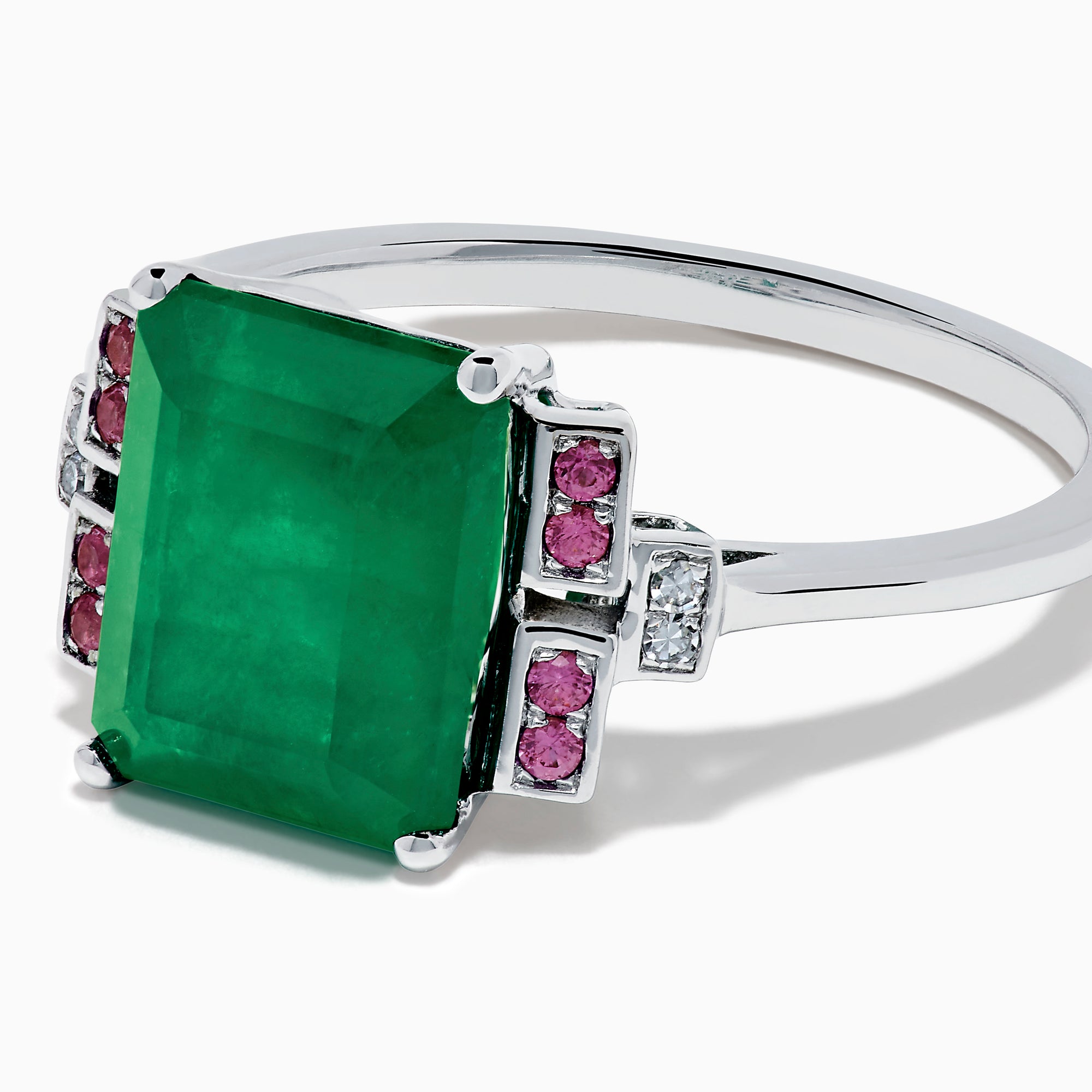 The 14K White Gold Emerald, Pink Sapphire, and Diamond Ring features a vibrant green emerald accented by pink sapphires and diamonds in modern geometric settings for an elegant look.