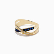 The Royale Bleu 14K Yellow Gold Blue Sapphire and Diamond Crossover Ring features two overlapping bands: one set with diamonds, the other adorned with vivid blue sapphires.