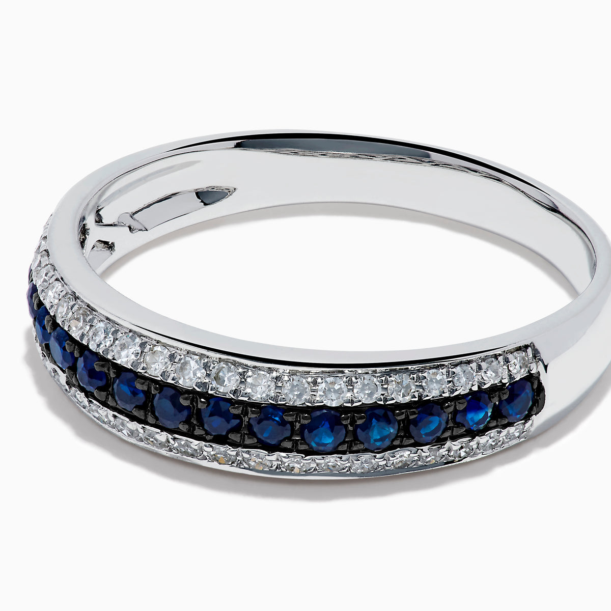 The 14K White Gold Pave Blue Sapphire and Diamond Band features a central row of blue sapphires bordered by sparkling diamonds, displayed on a plain white background.