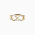 The 14K Yellow Gold Diamond Infinity Pinky Ring features an infinity symbol encrusted with small diamonds, creating a stunning statement piece against a plain white background.