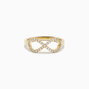The 14K Yellow Gold Diamond Infinity Pinky Ring features an infinity symbol encrusted with small diamonds, creating a stunning statement piece against a plain white background.
