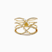 The D'Oro 14K Yellow Gold Interlaced Crisscross Diamond Ring features overlapping bands adorned with small diamonds and baguette-cut stones in a striking crisscross pattern, displayed on a white background.