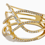 The D'Oro 14K Yellow Gold Interlaced Crisscross Diamond Ring features overlapping bands adorned with small diamonds and baguette-cut stones in a striking crisscross pattern, displayed on a white background.