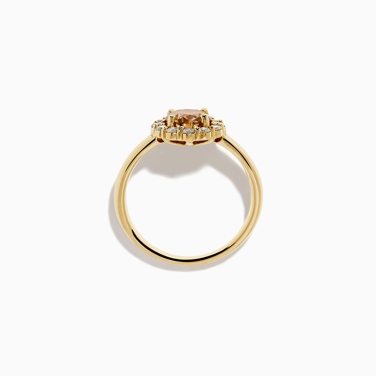 The 14K Yellow Gold Brown and White Diamond Halo Ring features a round brown and white diamond center, accented by a halo of sparkling small white diamonds.