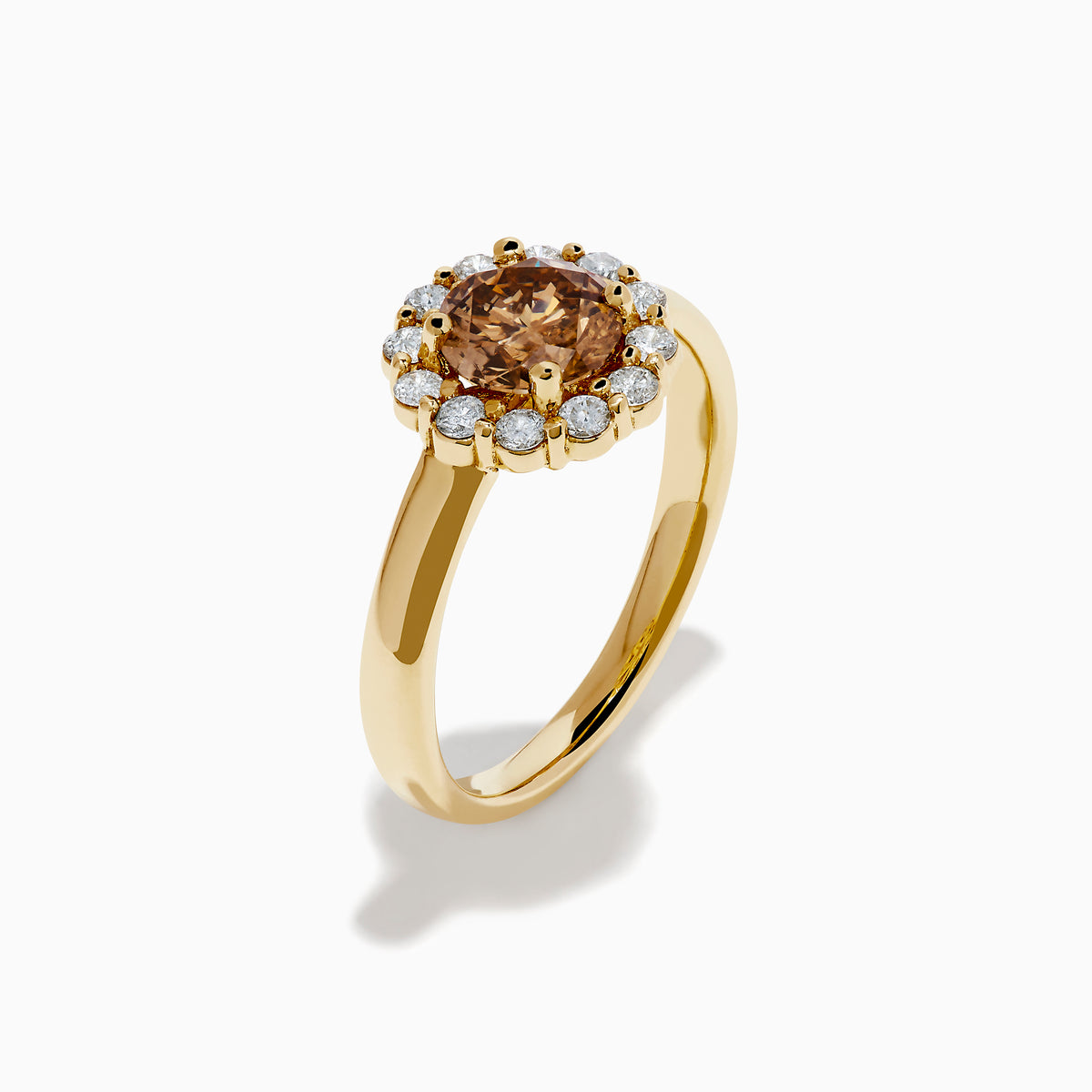 The 14K Yellow Gold Brown and White Diamond Halo Ring features a round brown and white diamond center, accented by a halo of sparkling small white diamonds.