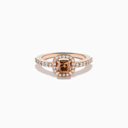 The Espresso 14K Rose Gold Brown and White Diamond Ring showcases a cushion-cut brown center stone, surrounded by a halo of white diamonds with extra diamonds adorning the band.
