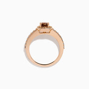The Espresso 14K Rose Gold Brown and White Diamond Ring showcases a cushion-cut brown center stone, surrounded by a halo of white diamonds with extra diamonds adorning the band.