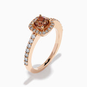 The Espresso 14K Rose Gold Brown and White Diamond Ring showcases a cushion-cut brown center stone, surrounded by a halo of white diamonds with extra diamonds adorning the band.