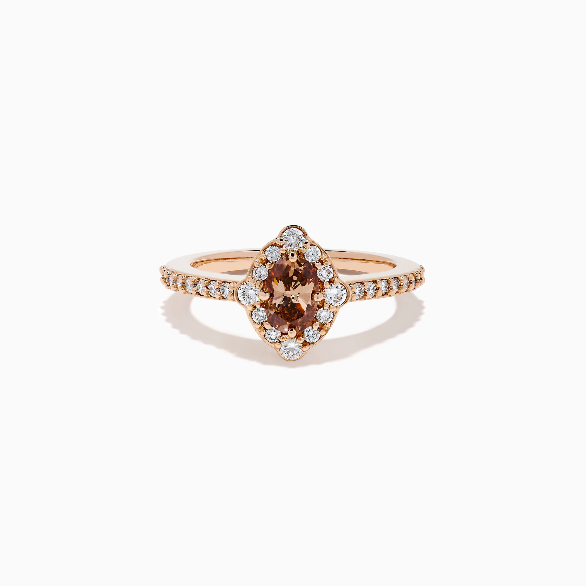 The 14K Rose Gold Brown and White Diamond Halo Ring showcases an oval brown and white diamond center, encircled by a halo of white diamonds and set with additional diamonds along the band.