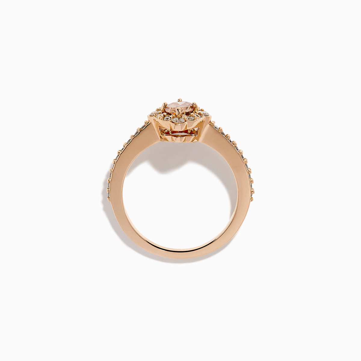 The 14K Rose Gold Brown and White Diamond Halo Ring showcases an oval brown and white diamond center, encircled by a halo of white diamonds and set with additional diamonds along the band.