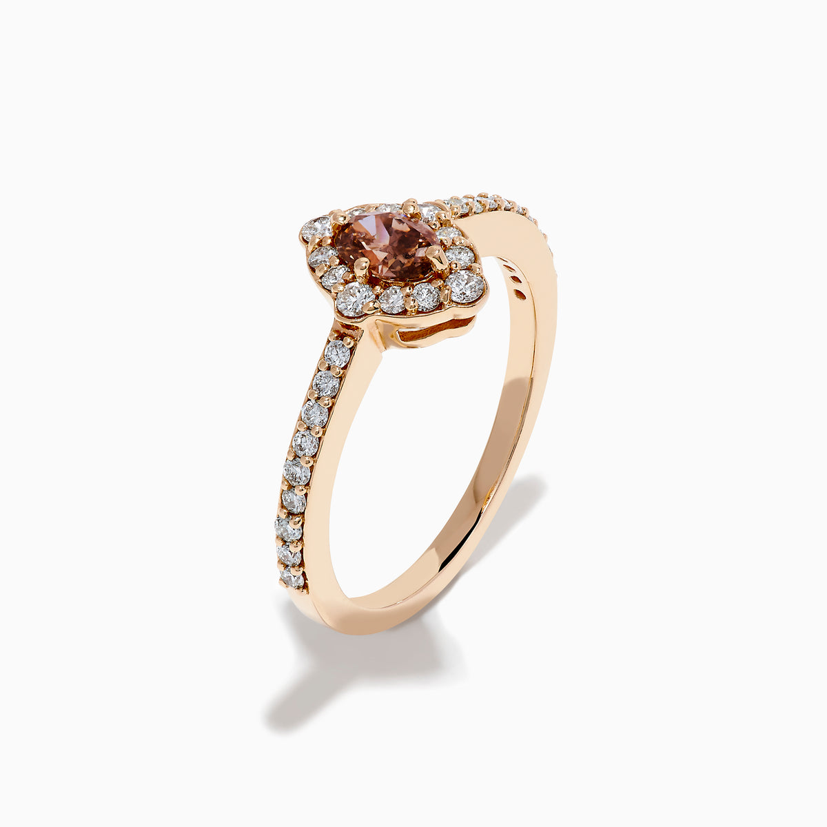 The 14K Rose Gold Brown and White Diamond Marquise Halo Ring features a marquise-cut brown and white diamond centerpiece, accented by round diamonds in a halo and along the band.