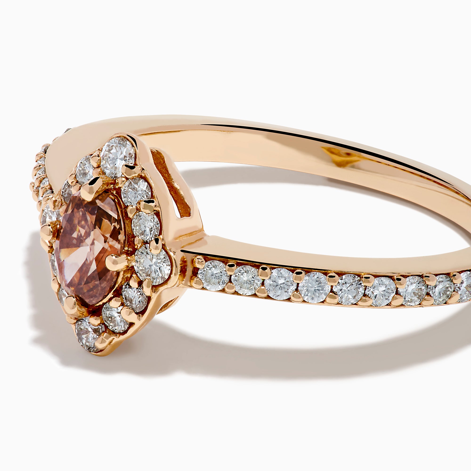The 14K Rose Gold Brown and White Diamond Marquise Halo Ring features a marquise-cut brown and white diamond centerpiece, accented by round diamonds in a halo and along the band.