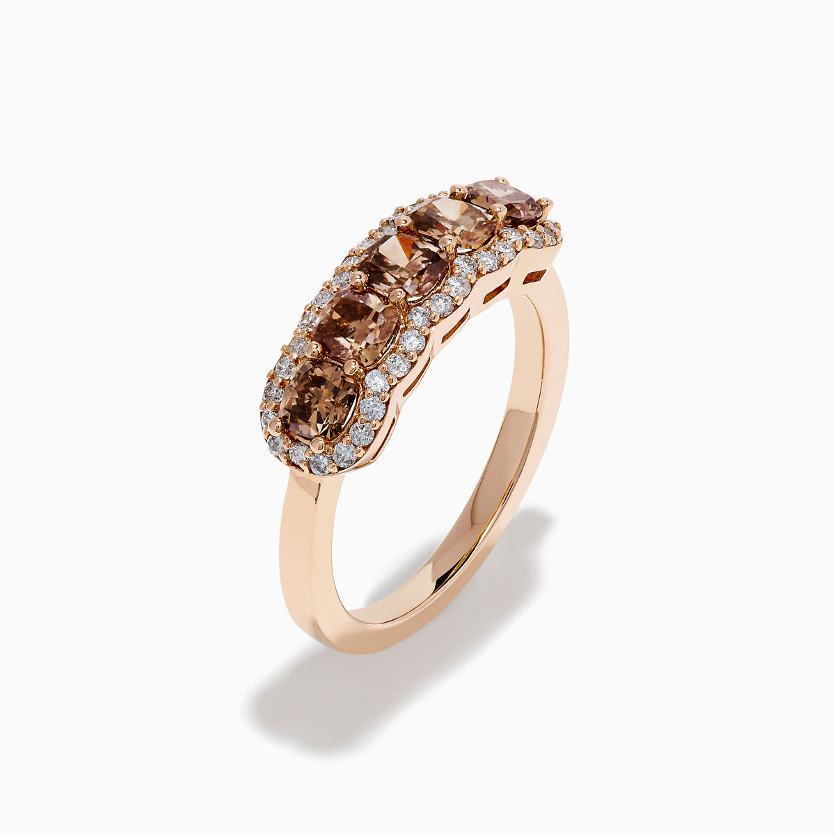 The 14K Rose Gold Cushion Cut 5 Stone Brown Diamond Band showcases five brown cushion-cut diamonds accented by round white diamonds, creating an elegant and sophisticated look.