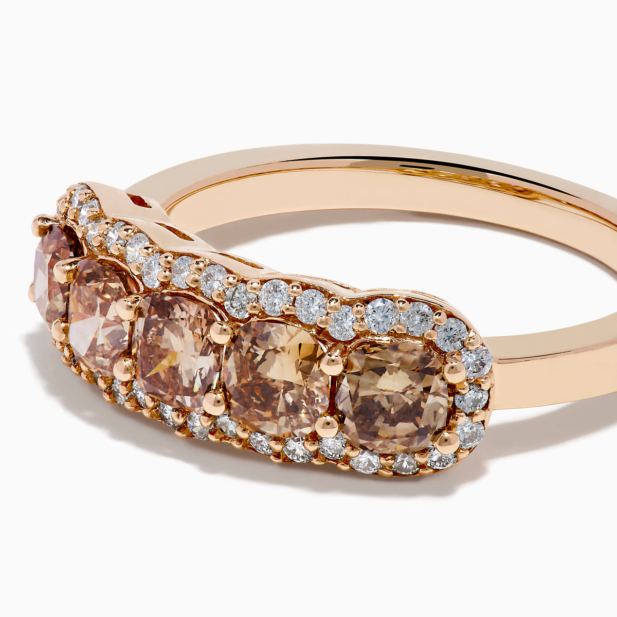 The 14K Rose Gold Cushion Cut 5 Stone Brown Diamond Band showcases five brown cushion-cut diamonds accented by round white diamonds, creating an elegant and sophisticated look.