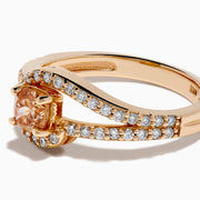 The 14K Rose Gold Brown and White Diamond Ring features a rectangular orange gemstone at the center, accented by two rows of sparkling white diamonds that gracefully curve and split around the vibrant stone.
