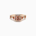 The Espresso 14K Rose Gold Brown Diamond Ring features a stunning brown diamond center with a halo of white diamonds and additional diamonds accenting its elegant twisted band.