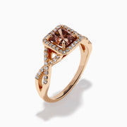 The Espresso 14K Rose Gold Brown Diamond Ring features a stunning brown diamond center with a halo of white diamonds and additional diamonds accenting its elegant twisted band.