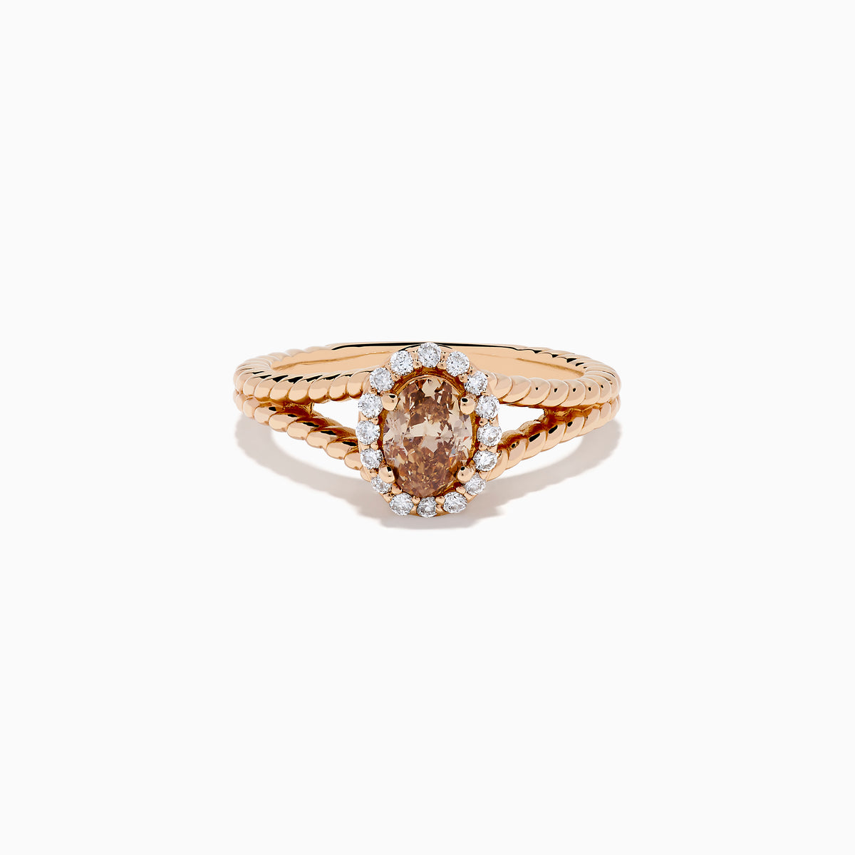 The Espresso 14K Rose Gold Brown Diamond Ring features an oval light brown diamond surrounded by a halo of small white diamonds and set on a twisted rose gold band.