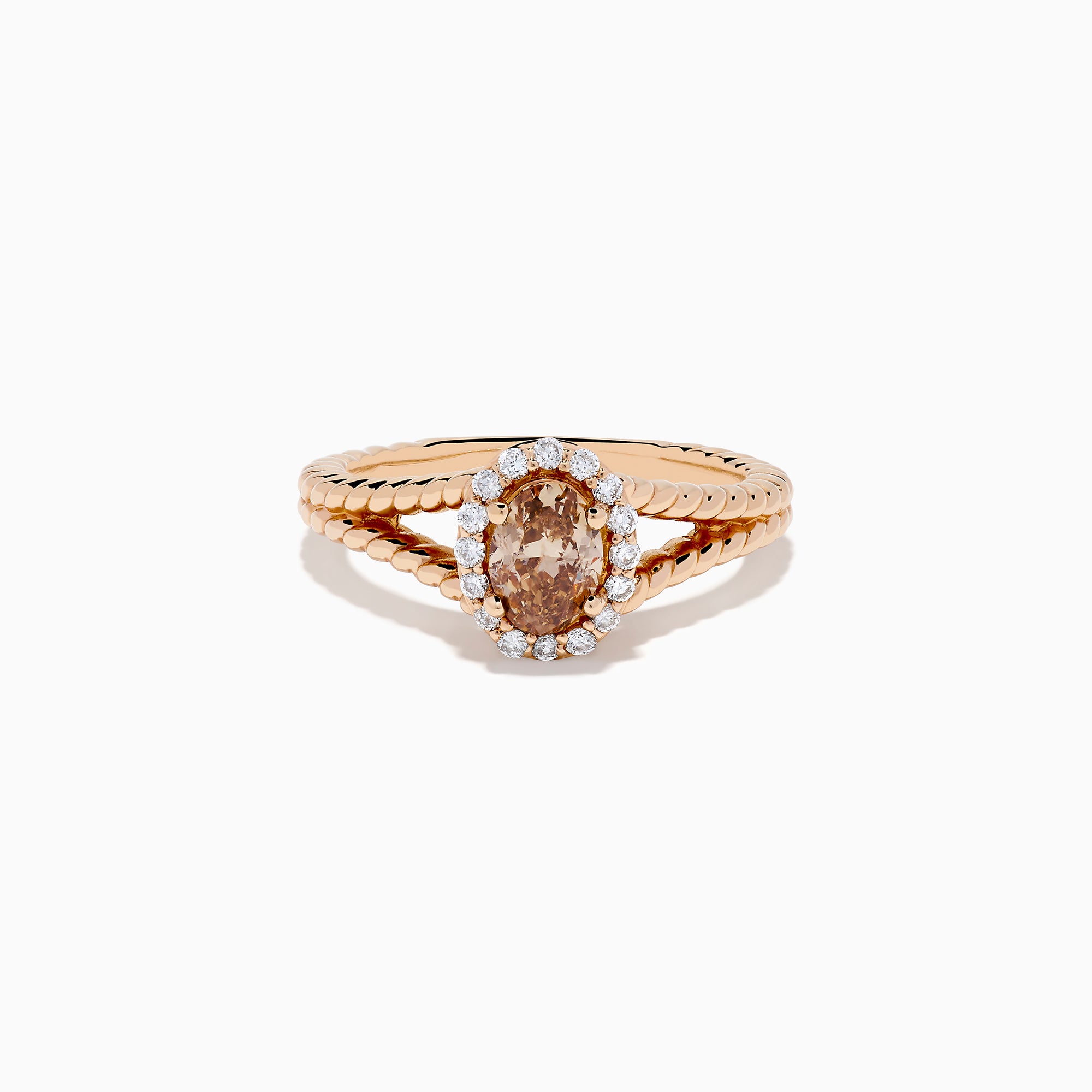 The Espresso 14K Rose Gold Brown Diamond Ring features an oval light brown diamond surrounded by a halo of small white diamonds and set on a twisted rose gold band.