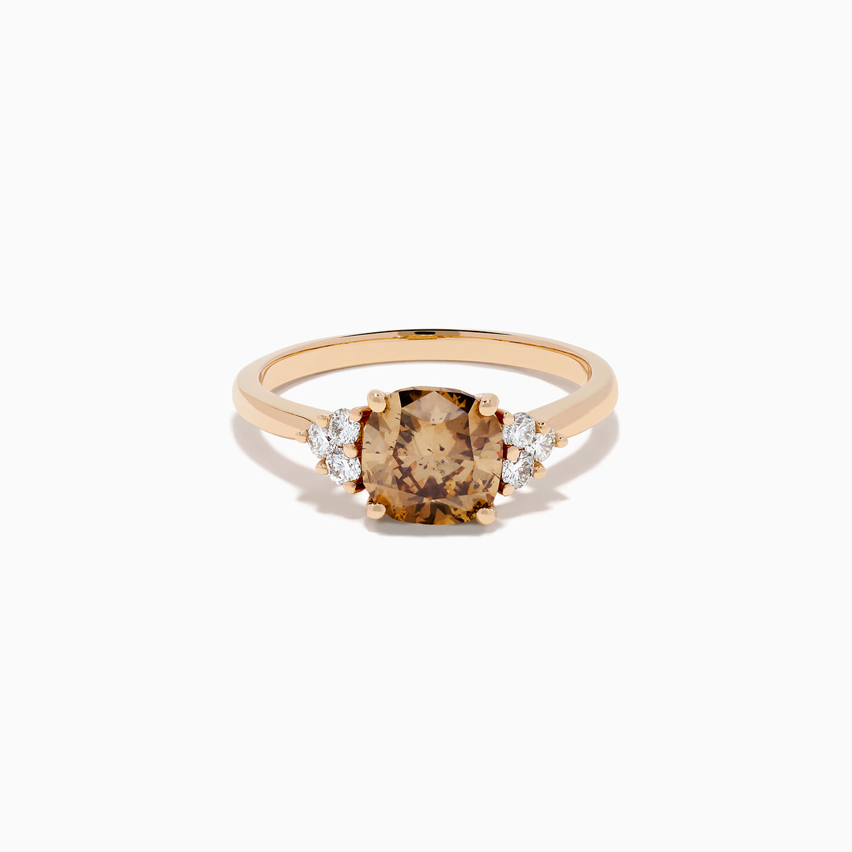 The 14K Rose Gold Cushion Cut Brown and White Diamond Ring features a central cushion-cut brown and white diamond with three small white diamonds on each side, all set in rose gold against a white background.