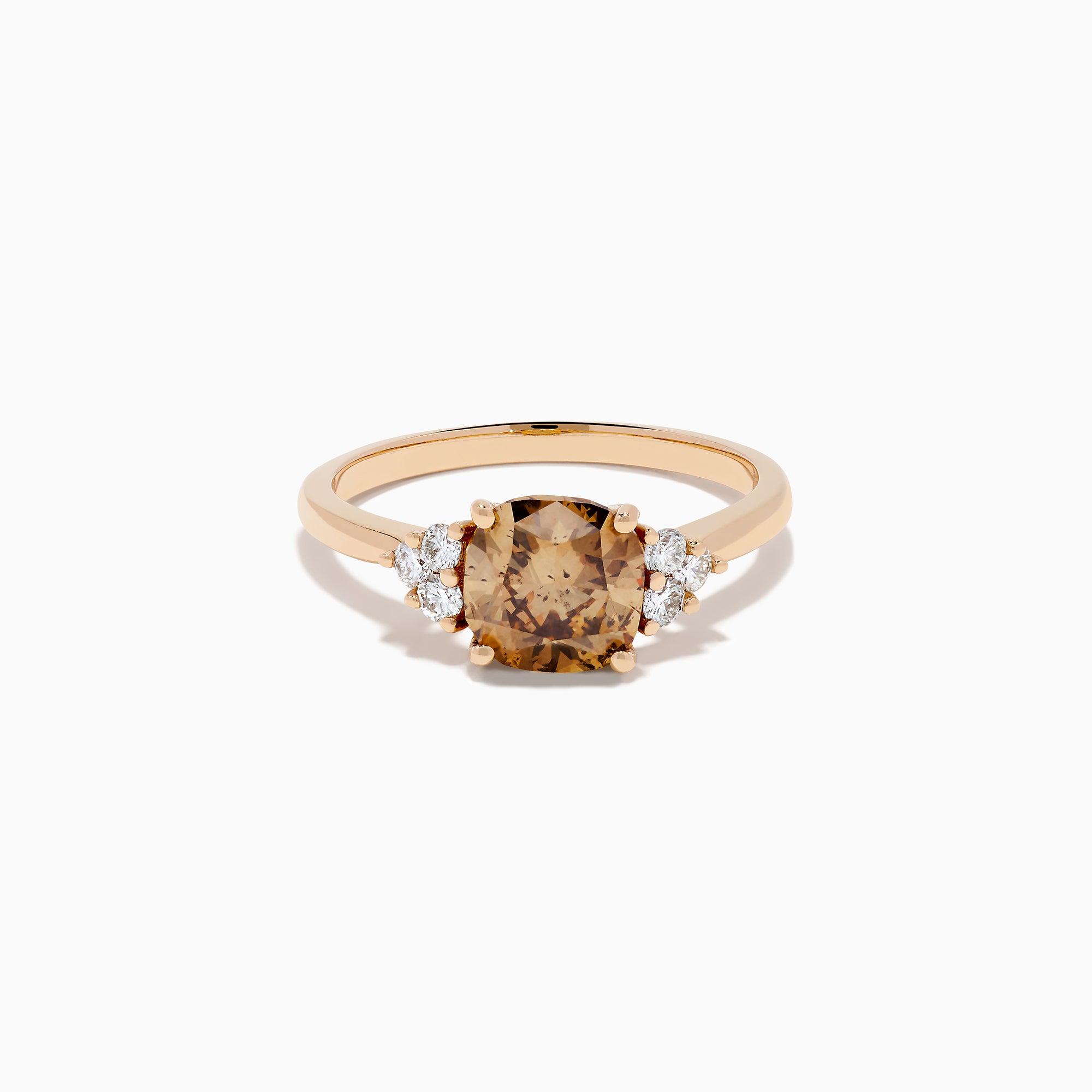 The 14K Rose Gold Cushion Cut Brown and White Diamond Ring features a central cushion-cut brown and white diamond with three small white diamonds on each side, all set in rose gold against a white background.