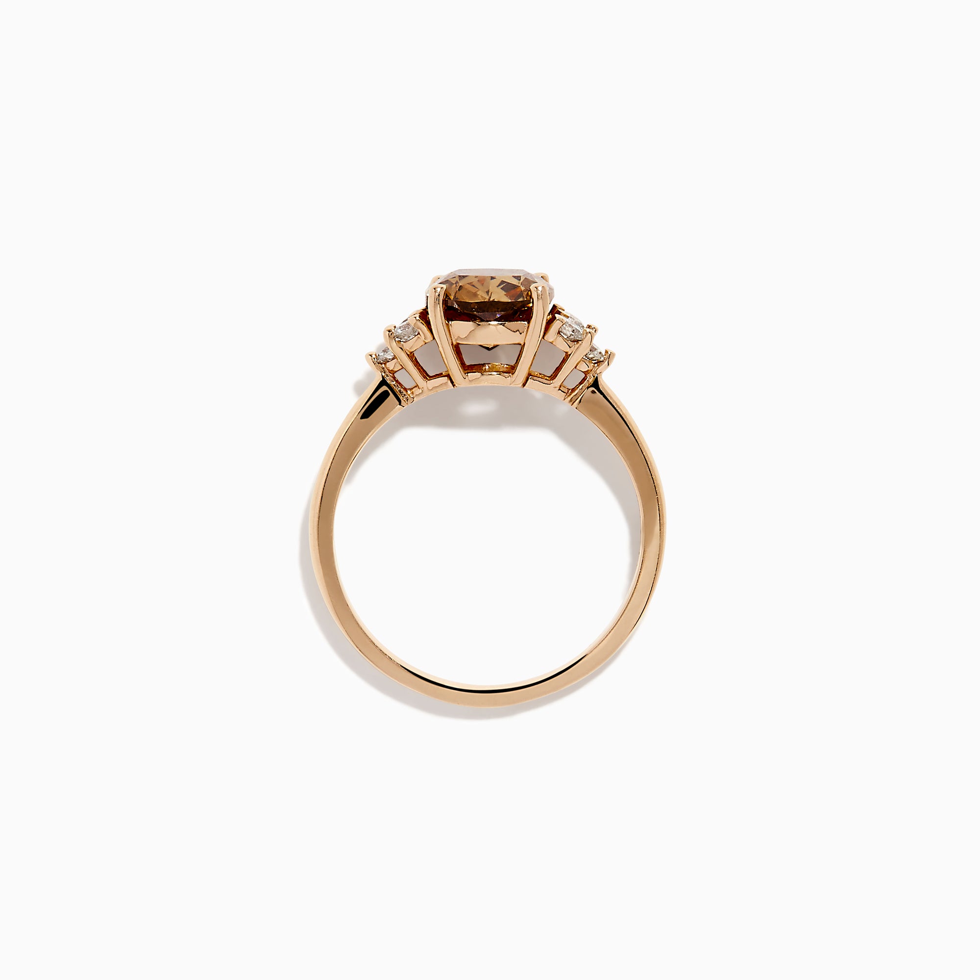 The 14K Rose Gold Cushion Cut Brown and White Diamond Ring features a central cushion-cut brown and white diamond with three small white diamonds on each side, all set in rose gold against a white background.