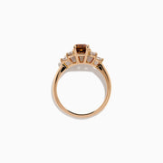 The 14K Rose Gold Brown and White Diamond Ring features a rectangular brown gemstone at the center with three round white diamonds on each side, all set in a simple rose gold band against a white background.