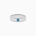 The Men's 14K White Gold Blue Diamond Ring showcases a single round blue diamond set into a sleek white gold band, shown on a plain white background.