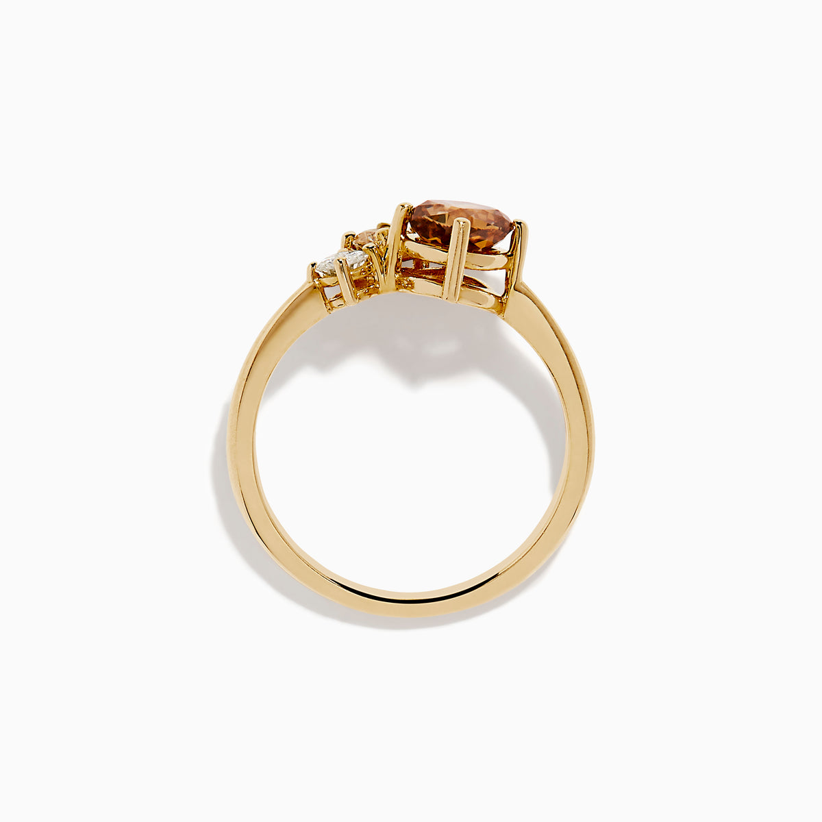 The Espresso 14K Yellow Gold Brown and White Diamond Ring showcases a round white diamond, a pear-shaped light brown diamond, and a cushion-cut brown diamond in a minimalist design against a white background.