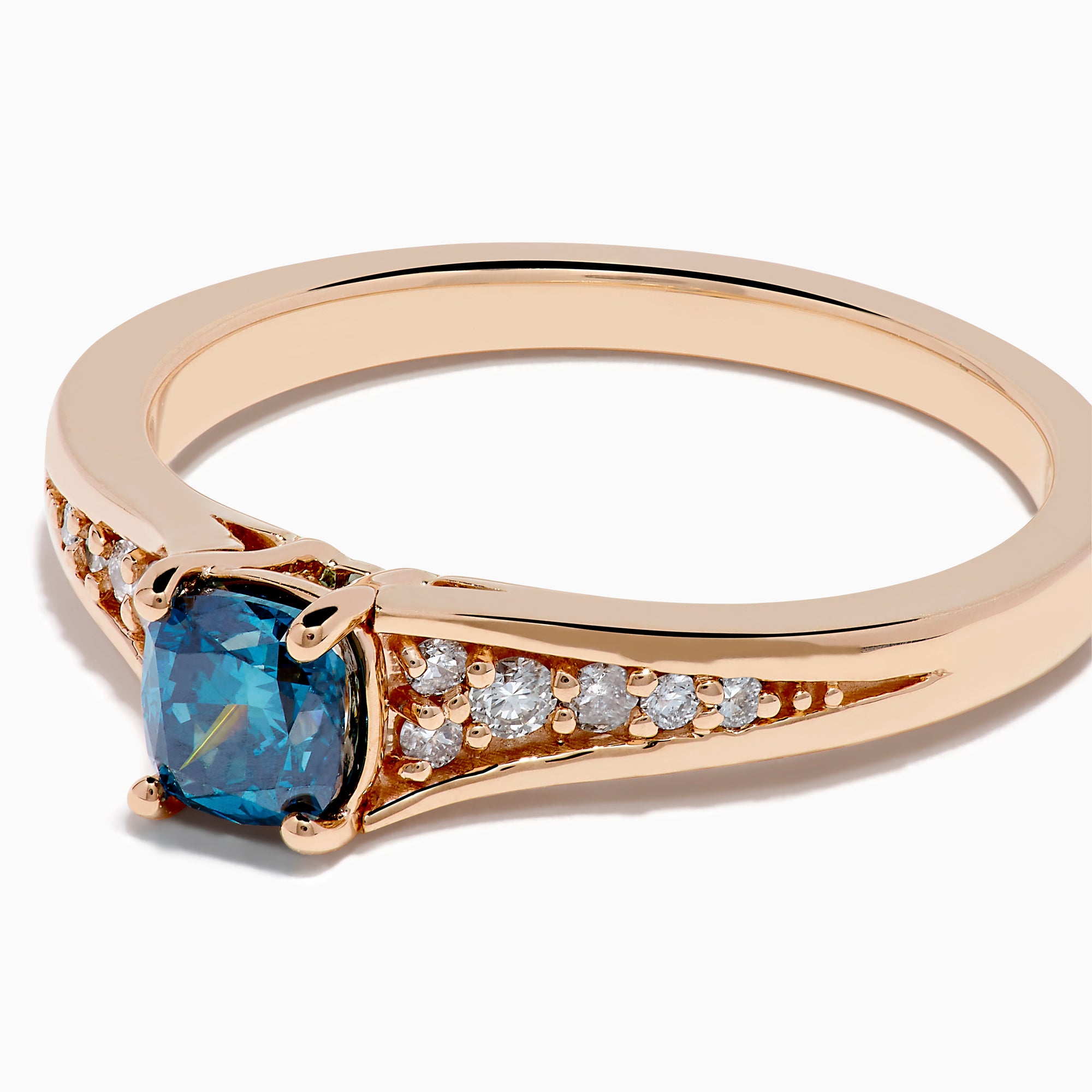 The Bella Bleu 14K Rose Gold Blue and White Diamond Ring showcases a blue rectangular gemstone at the center with small round white diamonds on each side, set against a plain white background.