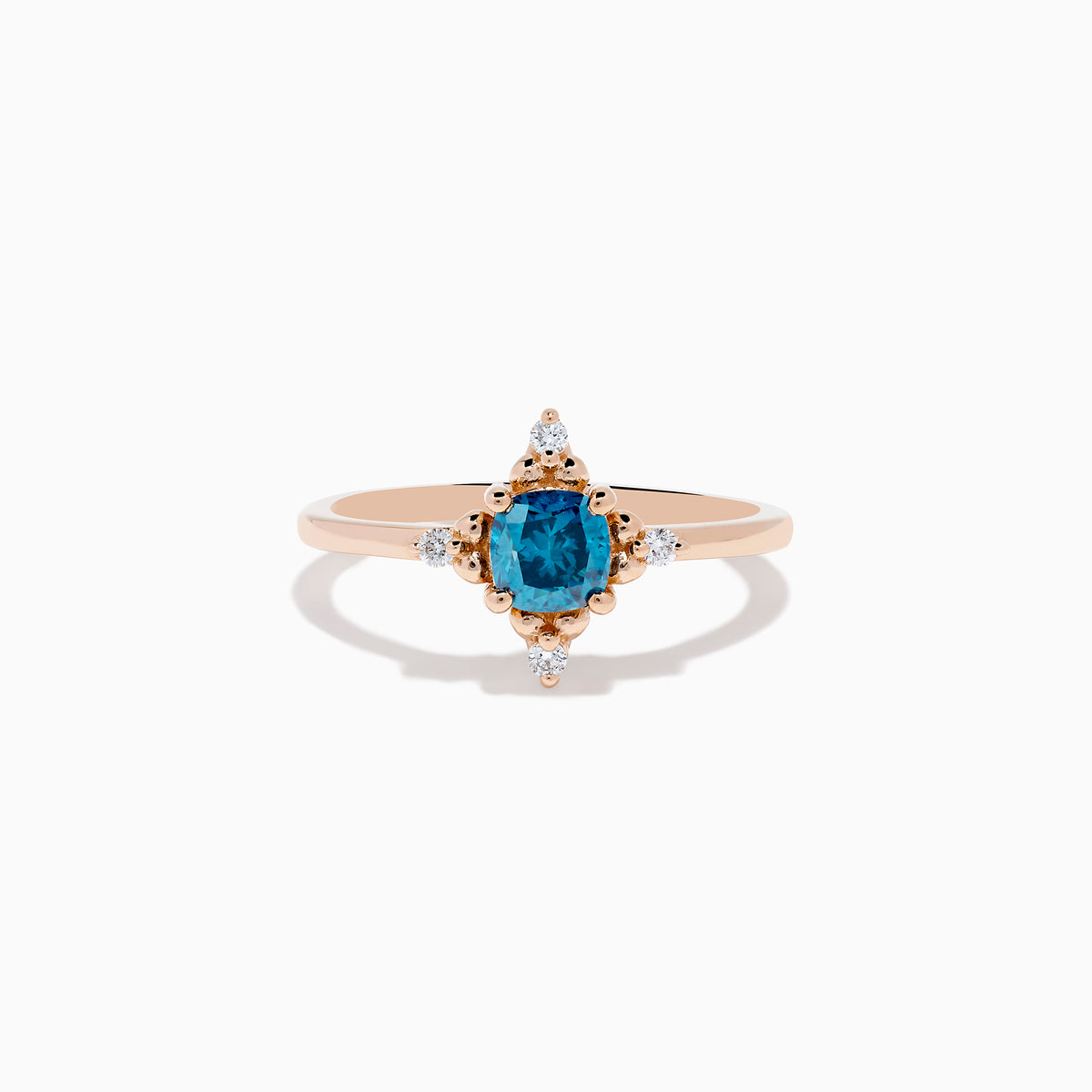 The Bella Bleu 14K Rose Gold Blue and White Diamond Ring features a cushion-cut blue gemstone at its center, accented by four symmetrically placed round white diamonds.