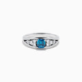 The Bella Bleu 14K White Gold Blue and White Diamond Ring showcases a vibrant square-cut blue center stone, accented by rows of round white diamonds on each side, displayed on a white background.