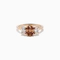 A close-up of the 14K Rose Gold Brown and White Diamond 3 Stone Ring, showcasing its beautiful brown and white diamonds in an elegant setting.