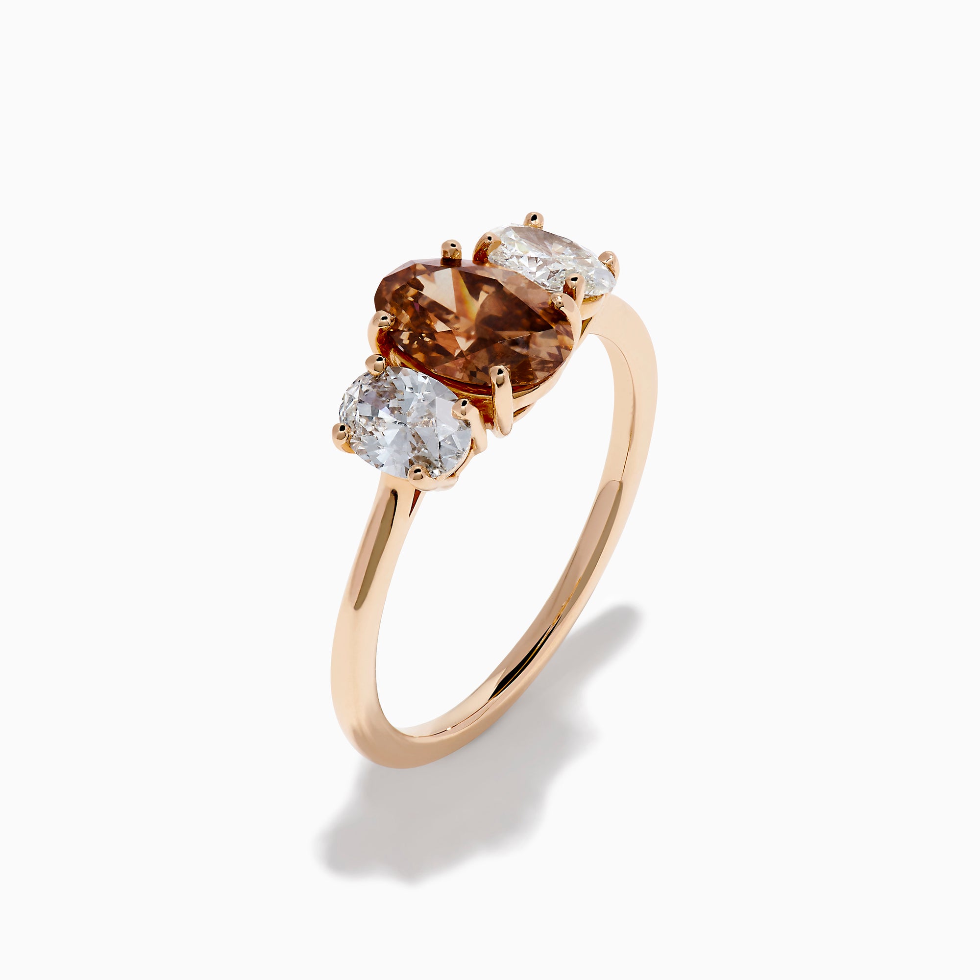 A close-up of the 14K Rose Gold Brown and White Diamond 3 Stone Ring, showcasing its beautiful brown and white diamonds in an elegant setting.