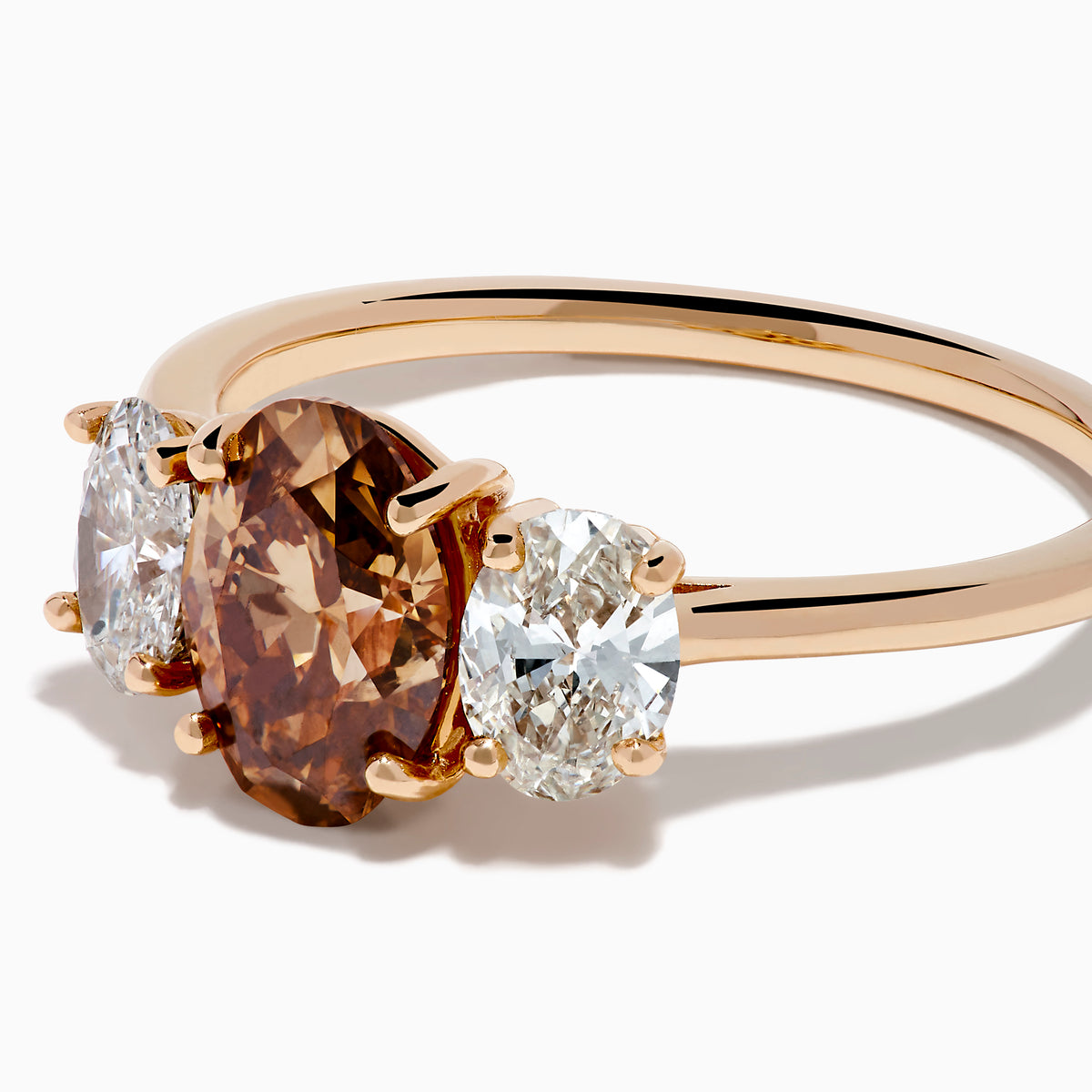 A close-up of the 14K Rose Gold Brown and White Diamond 3 Stone Ring, showcasing its beautiful brown and white diamonds in an elegant setting.