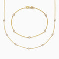 The DOro 14K Gold Diamond Station Necklace and Bracelet Set (0.59 TCW) features evenly spaced round diamonds on delicate chains, beautifully displayed on a white background.