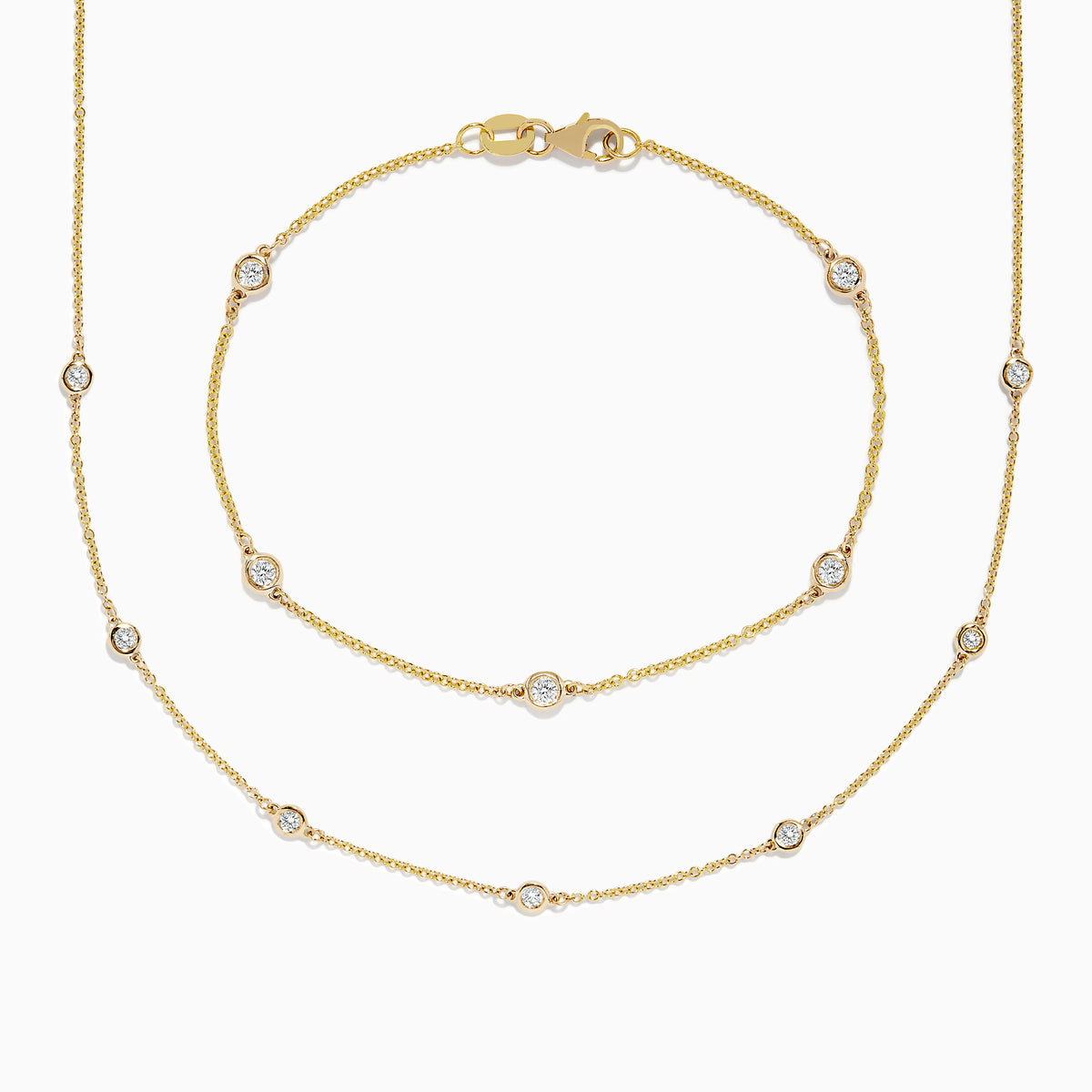 The DOro 14K Gold Diamond Station Necklace and Bracelet Set (0.59 TCW) features evenly spaced round diamonds on delicate chains, beautifully displayed on a white background.