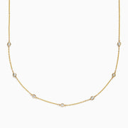 The DOro 14K Gold Diamond Station Necklace and Bracelet Set (0.59 TCW) features evenly spaced round diamonds on delicate chains, beautifully displayed on a white background.