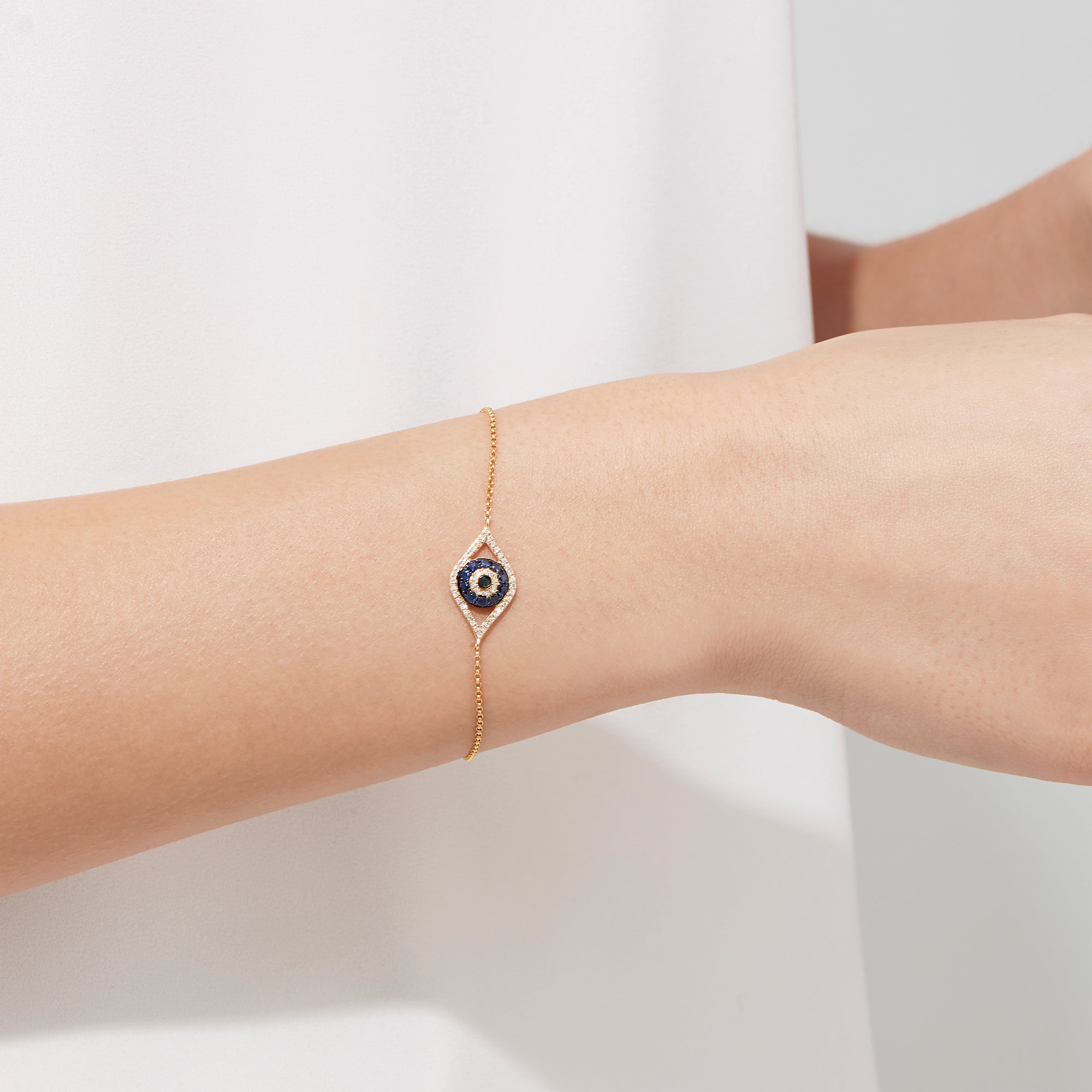 Novelty 14K Yellow Gold Sapphire & Diamond Evil Eye Bracelet, 0.43 TCW, features an eye-shaped charm with blue sapphire and diamonds, finished with a secure lobster clasp.