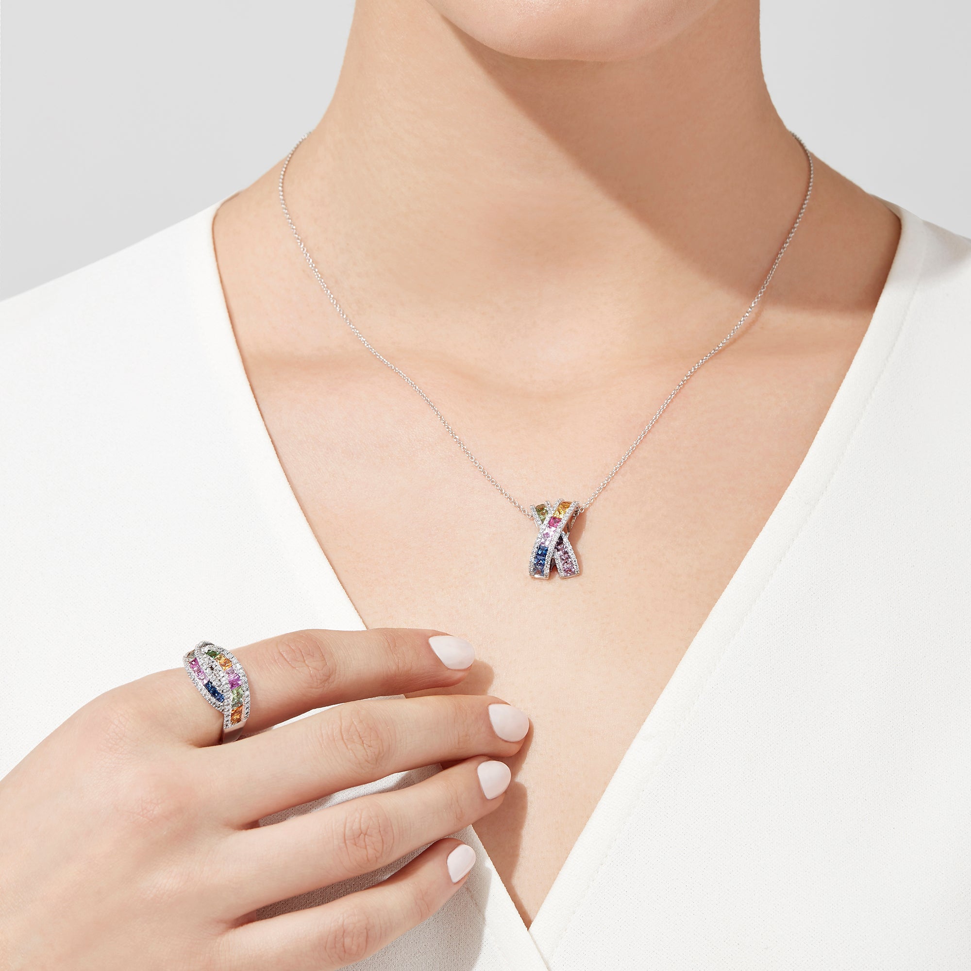 The Watercolors 14K White Gold Multi Sapphire and Diamond Ring, 1.95 TCW, features two intertwined bands set with rainbow-hued square-cut sapphires and bordered by rows of sparkling round diamonds.
