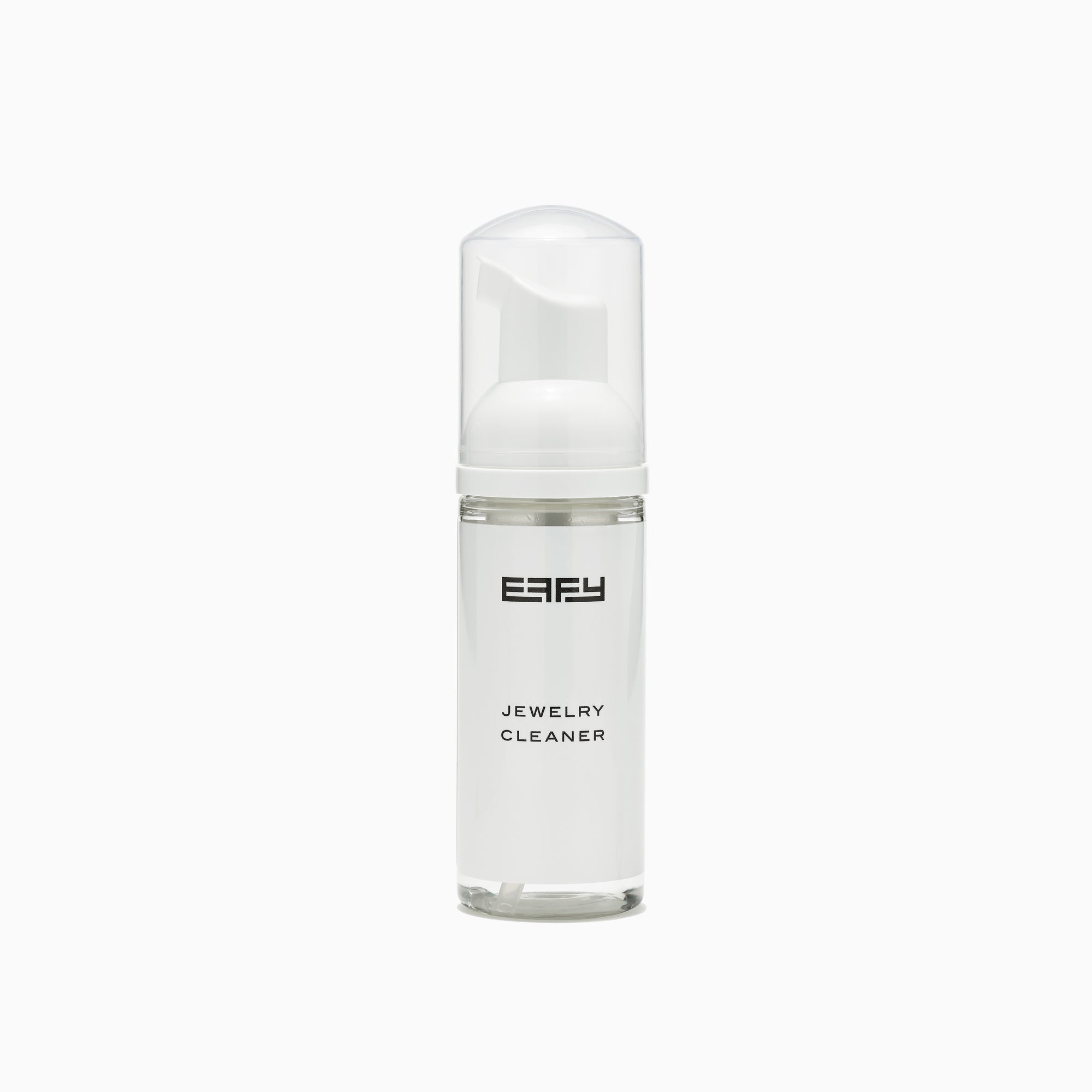 A white bottle labeled Jewelry Cleaner with a clear cap and pump sits next to a white cleaning brush on a plain white background—ideal for keeping your gemstone jewelry and diamonds sparkling.